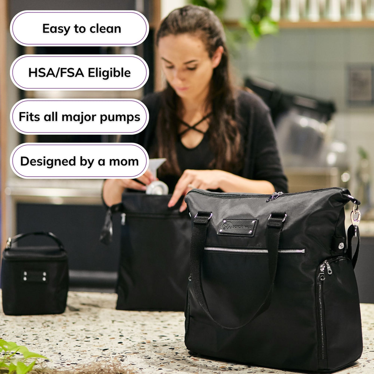 Woman carrying the Sarah Wells Lizzy pump tote in Black, with badges for easy to clean, HSA/FSA eligible, fits all major pumps, and designed by a mom
