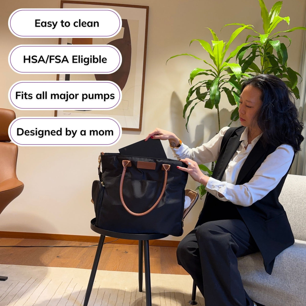 Woman carrying the Sarah Wells Abby pump tote in black with badges for easy to clean, HSA/FSA eligible, fits all major pumps, and designed by a mom