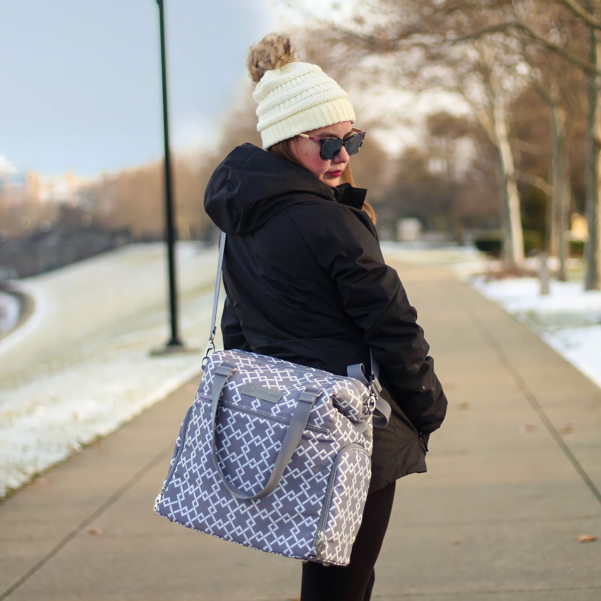 Woman carrying the Sarah Wells Lizzy pump tote in gray in a real-world setting
