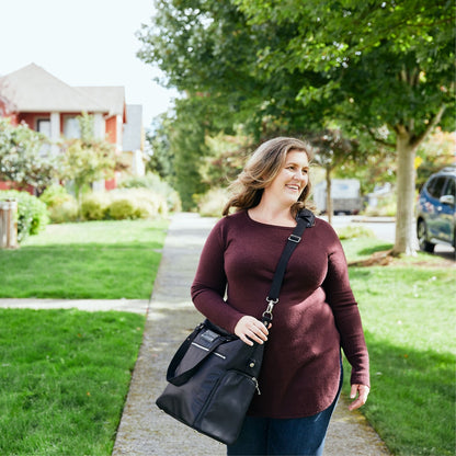 Woman carrying the Sarah Wells Lizzy pump tote in Black in a real-world setting