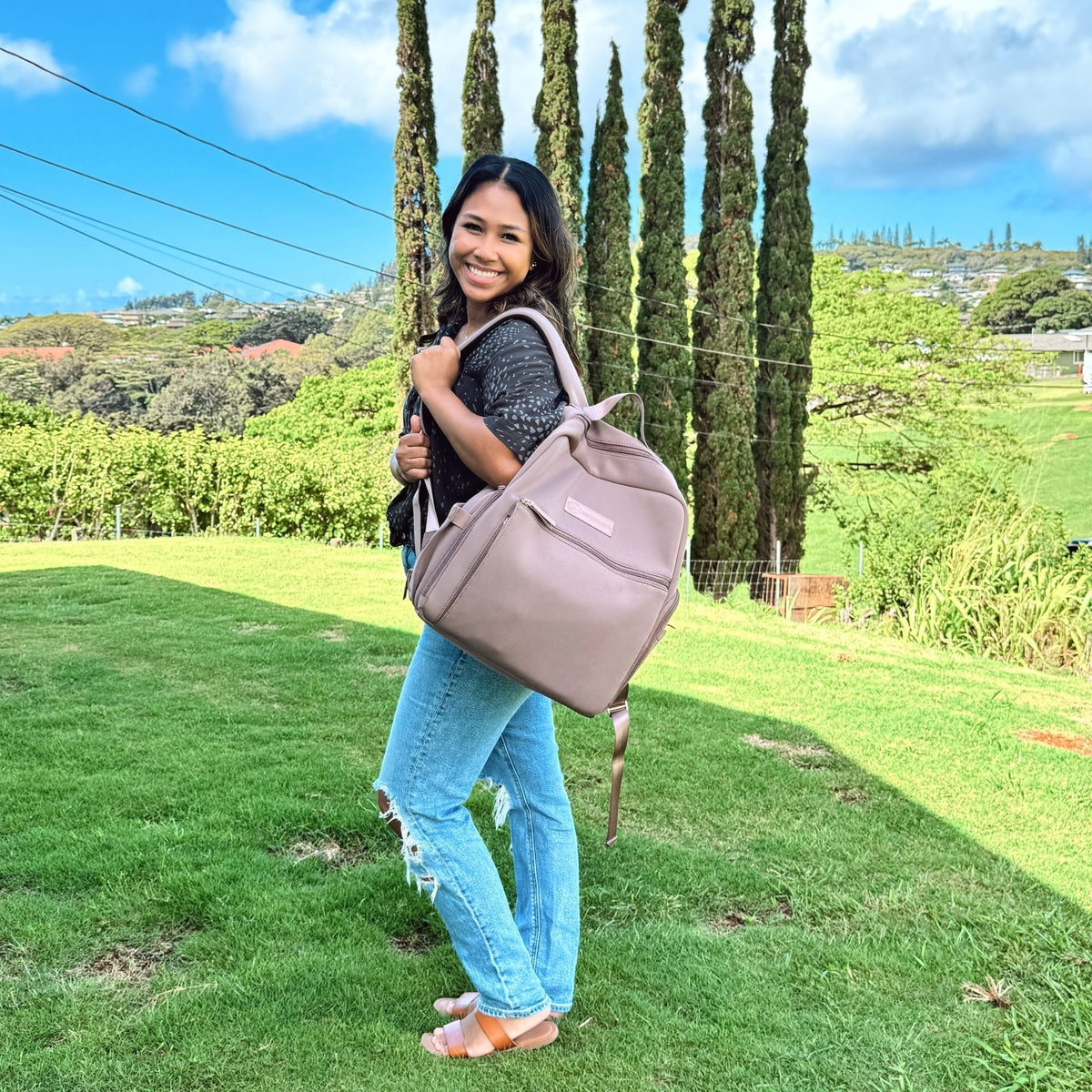 Woman wearing the Sarah Wells Fiona pump backpack in Earth to work or as a diaper bag