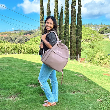 Woman wearing the Sarah Wells Fiona pump backpack in Earth to work or as a diaper bag