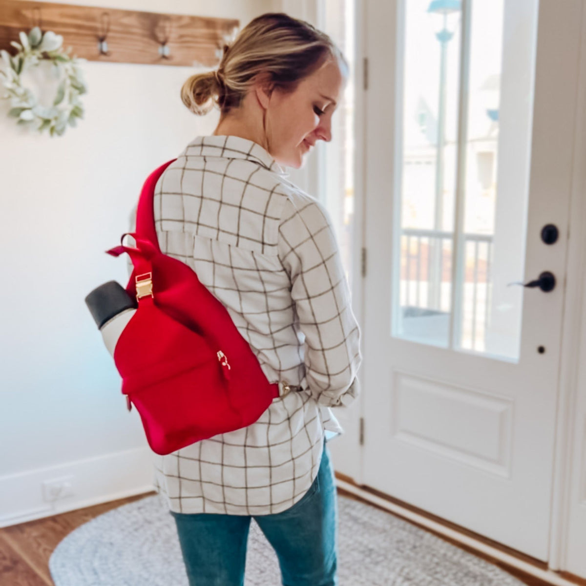 Woman wearing the Sarah Wells Allie pump sling in Ruby crossbody