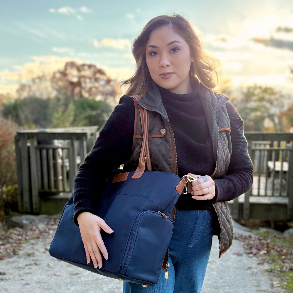 Woman carrying the Sarah Wells Abby pump tote in navy to work