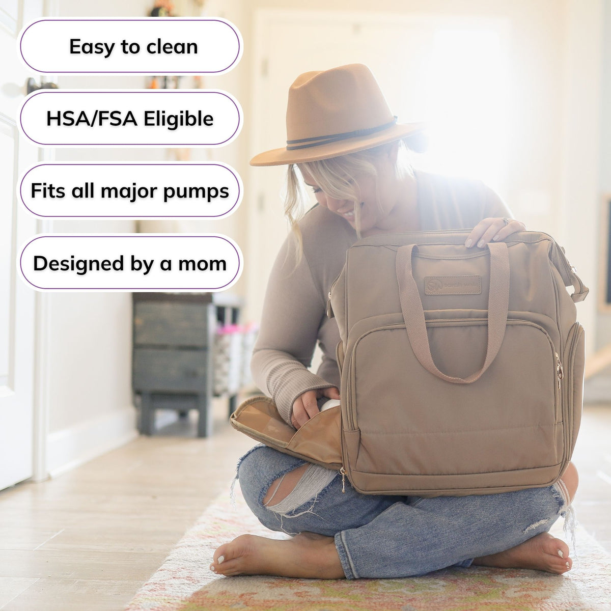 Woman carrying the Sarah Wells Norah pump backpack in latte, with badges for easy to clean, HSA/FSA eligible, fits all major pumps, and designed by a mom
