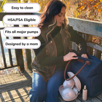 Woman carrying the Sarah Wells Abby pump tote in navy, with badges for easy to clean, HSA/FSA eligible, fits all major pumps, and designed by a mom