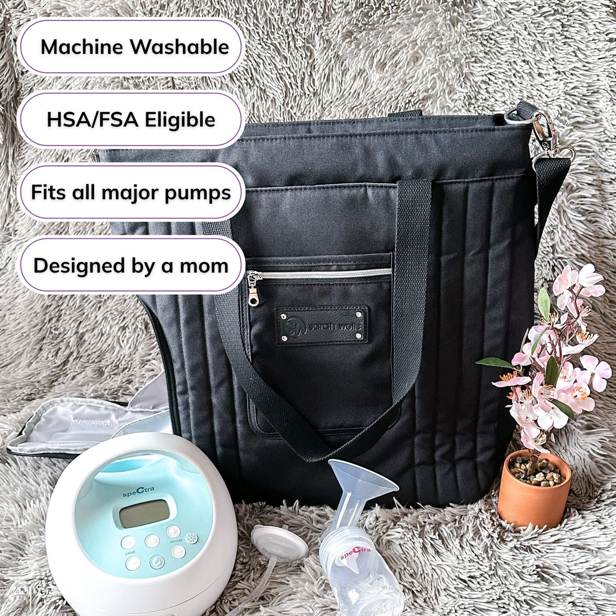 Woman carrying the Sarah Wells Suzy pump tote in Black, with badges for machine washable, HSA/FSA eligible, fits all major pumps, and designed by a mom