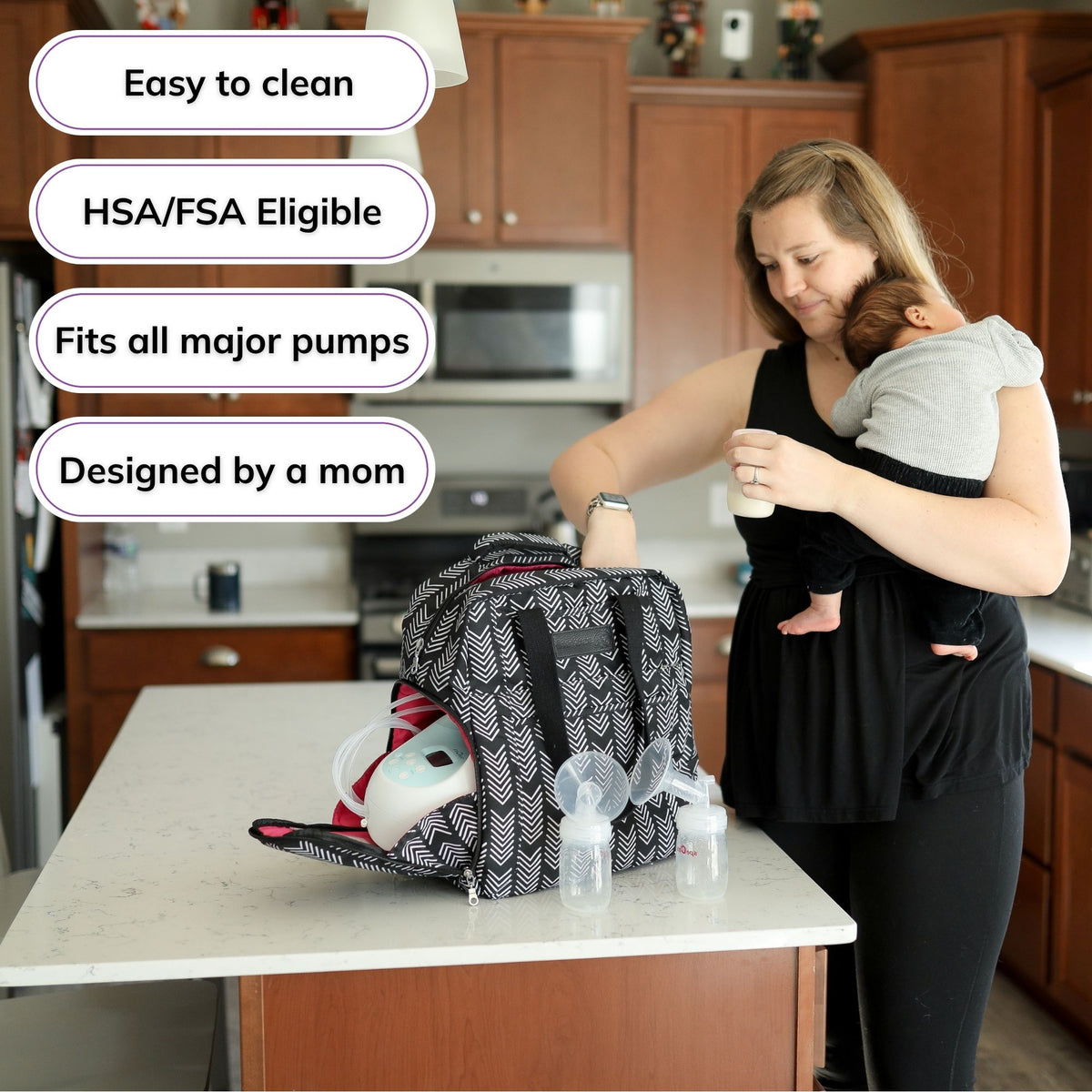 Woman carrying the Sarah Wells Kelly pump bag in Black &amp; White, with badges for easy to clean, HSA/FSA eligible, fits all major pumps, and designed by a mom